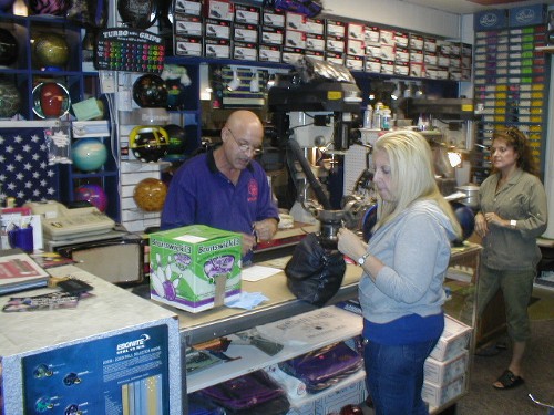 Ray DiSanto, Jr., owner of USA Bowling Pro Shops (and my coach) helping an unknown customer.  His wife Anna is in the right edge of the photo.